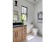 Chic half bathroom with modern fixtures, wood vanity, sleek mirror, and stylish decor for added elegance at 2745 S Bamby Ne Ln, Brookhaven, GA 30319