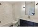 Modern bathroom features marble tile, sleek vanity, black hardware, and shower-tub combo at 2745 S Bamby Ne Ln, Brookhaven, GA 30319