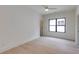 Spacious bedroom with light wood floors, large window, and neutral colors at 2745 S Bamby Ne Ln, Brookhaven, GA 30319