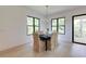 Elegant dining room with hardwood floors, modern lighting, and views of the outdoors at 2745 S Bamby Ne Ln, Brookhaven, GA 30319