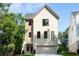 Charming home with brick exterior, black framed windows, and a two-car garage, set amongst lush landscaping at 2745 S Bamby Ne Ln, Brookhaven, GA 30319
