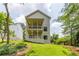 Two story exterior elevation with double porches surrounded by lush green trees at 2745 S Bamby Ne Ln, Brookhaven, GA 30319