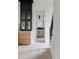 Hallway leading to a modern bathroom features sleek cabinets and a stylish staircase for added convenience at 2745 S Bamby Ne Ln, Brookhaven, GA 30319