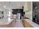 Bright kitchen features stainless appliances, light hardwood floors, an expansive island and marble countertops at 2745 S Bamby Ne Ln, Brookhaven, GA 30319