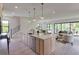 Bright, open-concept kitchen includes an island with seating, marble countertops, and is connected to the dining and living areas at 2745 S Bamby Ne Ln, Brookhaven, GA 30319
