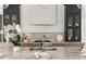 Close-up of the kitchen island featuring a marble countertop, stainless sink, and modern faucet at 2745 S Bamby Ne Ln, Brookhaven, GA 30319