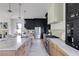 This kitchen offers two-tone cabinets, an island with barstool seating, pendant lighting, and stainless steel appliances at 2745 S Bamby Ne Ln, Brookhaven, GA 30319