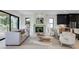 Bright and airy living room with a fireplace, a balcony, modern furnishings, and an open layout to the kitchen at 2745 S Bamby Ne Ln, Brookhaven, GA 30319