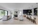 Open-concept living room with a fireplace, a sofa, and adjacent to a modern kitchen with barstool seating at 2745 S Bamby Ne Ln, Brookhaven, GA 30319