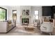 Bright living room featuring a fireplace, neutral furniture, and large windows offering natural light at 2745 S Bamby Ne Ln, Brookhaven, GA 30319