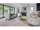 Sunlit living room featuring a fireplace, hardwood floors, and access to an outdoor patio at 2745 S Bamby Ne Ln, Brookhaven, GA 30319