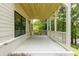 Covered porch with white railings and a view of the surrounding trees and landscaping at 2745 S Bamby Ne Ln, Brookhaven, GA 30319