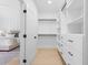 Bright, modern walk-in closet featuring custom shelving and drawers, adjacent to the main bedroom at 2745 S Bamby Ne Ln, Brookhaven, GA 30319