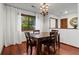Inviting dining room with wood floors, stylish light fixture and window overlooking the green outdoors at 895 Fawn Way, Marietta, GA 30068