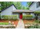 Inviting home entrance with a bright red door, stone details, and a walkway framed by manicured greenery at 895 Fawn Way, Marietta, GA 30068