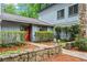 Inviting home entrance featuring a red door, stone accents, manicured greenery, and a stone-paved walkway at 895 Fawn Way, Marietta, GA 30068