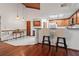 View of bar-style seating area in the kitchen and dining area with wood floors and light fixtures at 895 Fawn Way, Marietta, GA 30068