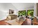 Bright living room with hardwood floors, large windows, a vaulted ceiling, and stylish, comfortable furnishings at 895 Fawn Way, Marietta, GA 30068