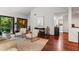 Bright living room with hardwood floors, large windows overlooking the patio, and comfortable furnishings at 895 Fawn Way, Marietta, GA 30068
