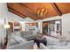 Spacious living room with hardwood ceiling, chandelier, and connection to kitchen and outdoor patio at 895 Fawn Way, Marietta, GA 30068