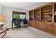 Office room featuring custom built-in bookshelves, large windows, and plenty of natural light at 895 Fawn Way, Marietta, GA 30068