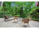 Outdoor patio area featuring stone pavers and lots of seating, surrounded by lush greenery at 895 Fawn Way, Marietta, GA 30068