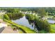 Aerial view exhibiting lake with lush landscaping and houses lining the sides at 1838 Lakeview Bend Way, Buford, GA 30519