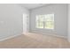Sunny bedroom with neutral carpet and a bright window at 1838 Lakeview Bend Way, Buford, GA 30519