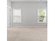 Bright bedroom with neutral carpet and two sunny windows at 1838 Lakeview Bend Way, Buford, GA 30519