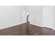 Spacious bedroom with hardwood floors, bright neutral paint, and doorways to other parts of the home at 1838 Lakeview Bend Way, Buford, GA 30519