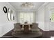 Staged dining room featuring modern chandelier, neutral tones, and wainscotting at 1838 Lakeview Bend Way, Buford, GA 30519