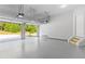 Open garage with an automatic door leading to the driveway and landscaping at 1838 Lakeview Bend Way, Buford, GA 30519