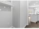 Hallway leading to the kitchen with white walls and hardwood floors and modern finishes at 1838 Lakeview Bend Way, Buford, GA 30519