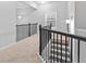 Hallway with metal railing, carpet floor and natural light at 1838 Lakeview Bend Way, Buford, GA 30519
