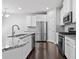 Modern kitchen featuring stainless steel appliances, granite countertops, and white cabinetry at 1838 Lakeview Bend Way, Buford, GA 30519