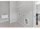 Small laundry room with sink, tile flooring and dryer hookup at 1838 Lakeview Bend Way, Buford, GA 30519