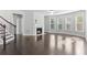 Bright living room with a fireplace, staircase, hardwood flooring, and multiple windows at 1838 Lakeview Bend Way, Buford, GA 30519