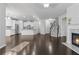Spacious living room featuring a modern kitchen, fireplace, and staircase at 1838 Lakeview Bend Way, Buford, GA 30519