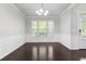 Spacious living room featuring hardwood floors, wainscotting, and abundant natural light at 1838 Lakeview Bend Way, Buford, GA 30519
