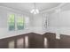 Spacious living room featuring hardwood floors, wainscotting, and abundant natural light at 1838 Lakeview Bend Way, Buford, GA 30519