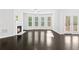 Bright living room with fireplace, hardwood floors, and large windows for natural light at 1838 Lakeview Bend Way, Buford, GA 30519