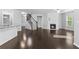Bright living room featuring a fireplace, staircase, and island kitchen at 1838 Lakeview Bend Way, Buford, GA 30519