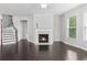 Bright living room features fireplace, dark wood floors, and lots of natural light at 1838 Lakeview Bend Way, Buford, GA 30519