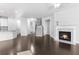 Open-concept living area with a fireplace, hardwood floors, and staircase at 1838 Lakeview Bend Way, Buford, GA 30519