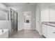 Modern main bathroom featuring a soaking tub and glass shower, open to main bedroom at 1838 Lakeview Bend Way, Buford, GA 30519