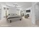 A bright, staged main bedroom with fireplace, large bed, sitting area and tray ceiling at 1838 Lakeview Bend Way, Buford, GA 30519