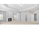 Bright and airy main bedroom with fireplace, trey ceilings, and doorway to bathroom at 1838 Lakeview Bend Way, Buford, GA 30519