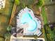 Overhead view showcasing the geometric design of the community pool surrounded by trees and lounge chairs at 1838 Lakeview Bend Way, Buford, GA 30519