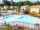 Well-kept community pool with lounge chairs, umbrella tables, and a fenced perimeter at 1838 Lakeview Bend Way, Buford, GA 30519