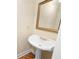 Bathroom featuring a pedestal sink, decorative mirror and gold hardware at 223 Oak Grove Dr, Dallas, GA 30157